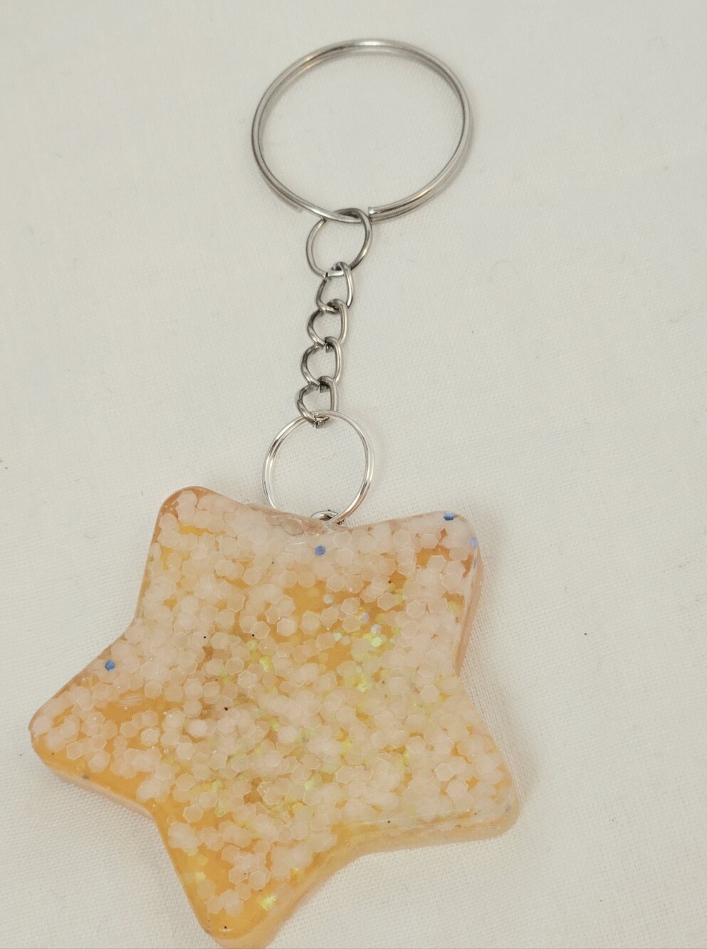 Glow In The Dark Star-Shaped Resin Keychain in Yellow Sparkle
